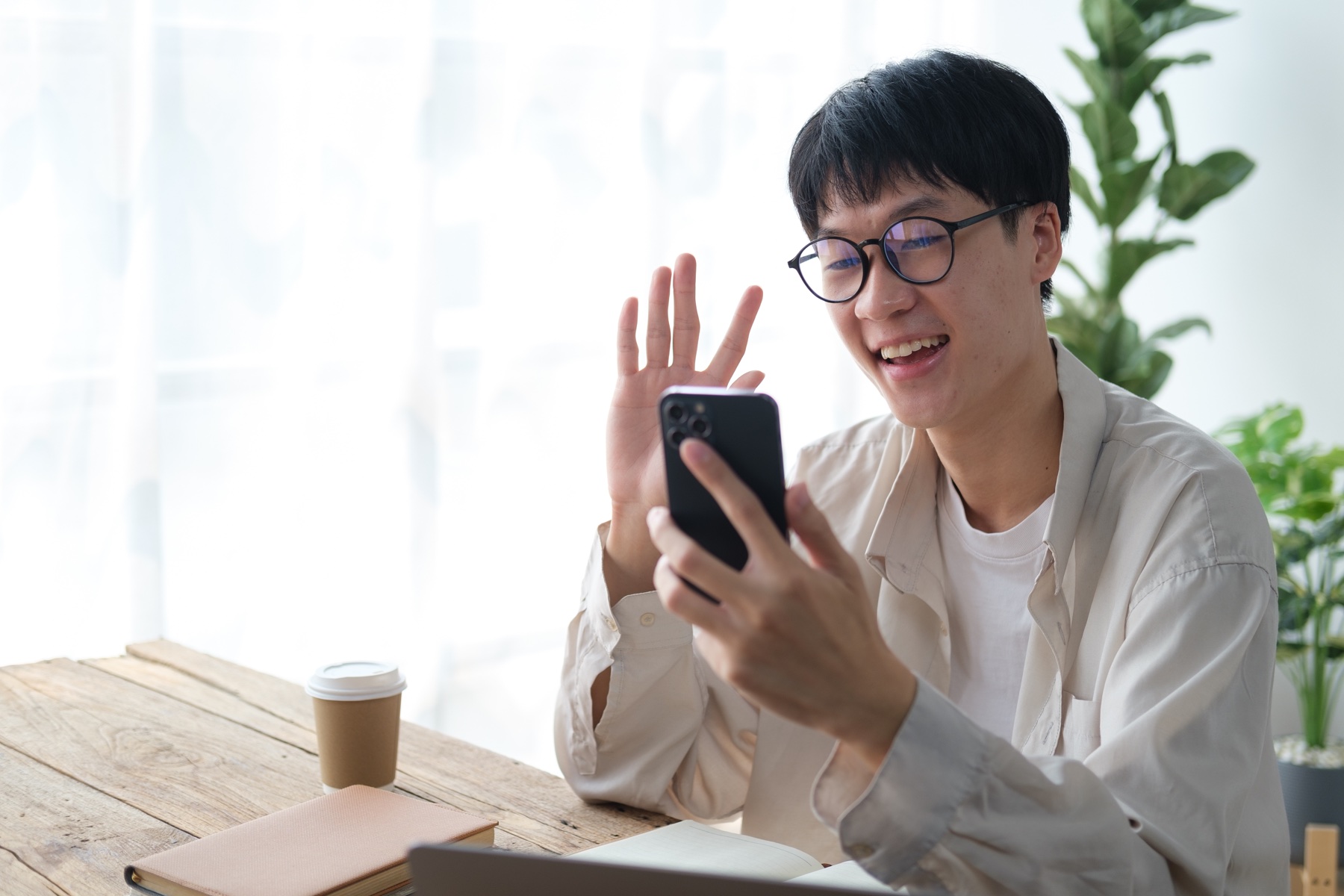 A coach greeting someone during a video call